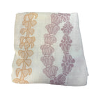 folded muslin baby swaddle blanket with hawaiian lei designs